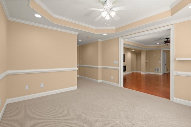 10565 Highgate Manor Ct, Duluth, GA 30097 - empty room featuring a raised ceiling, a ceiling fan, carpet, ornamental molding, and recessed lighting