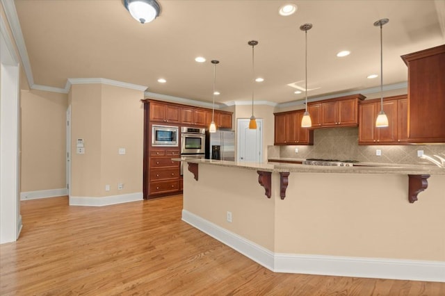 10565 Highgate Manor Ct, Duluth, GA 30097 - kitchen featuring stainless steel appliances, a kitchen bar, crown molding, tasteful backsplash, and brown cabinets