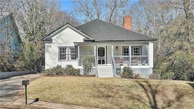 view of front of home with a front lawn and a porch