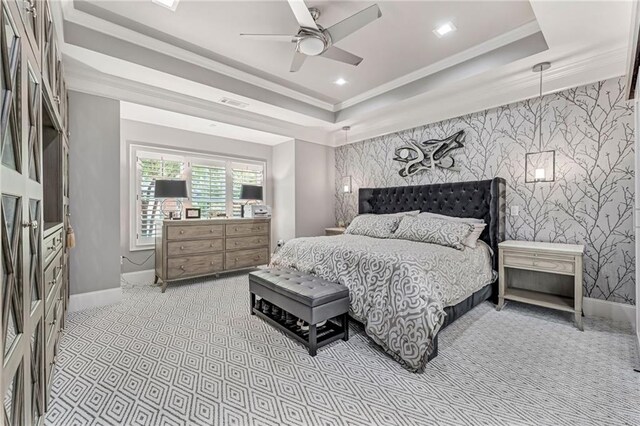 bedroom with ceiling fan, ornamental molding, and a tray ceiling