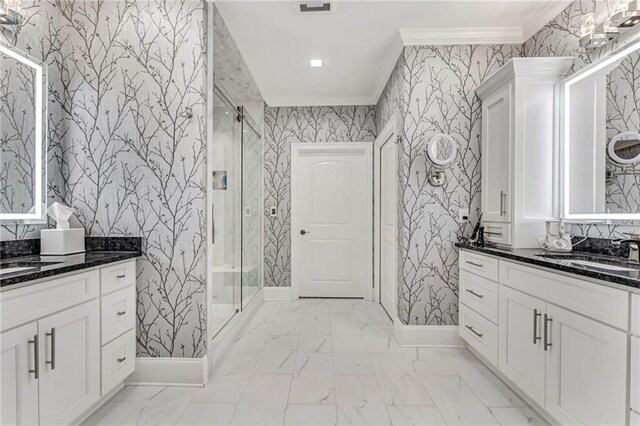 bathroom featuring vanity, a shower with door, and ornamental molding