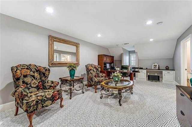 sitting room with vaulted ceiling