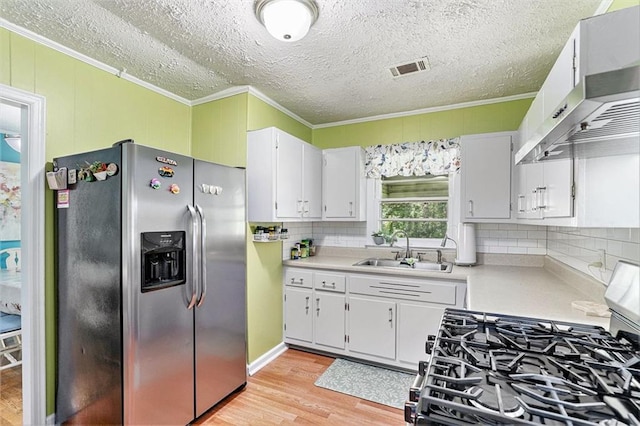 141 Parr Wade Rd SE, Cartersville, GA 30120 - kitchen featuring stainless steel appliances, ornamental molding, light wood-style flooring, light countertops, and decorative backsplash