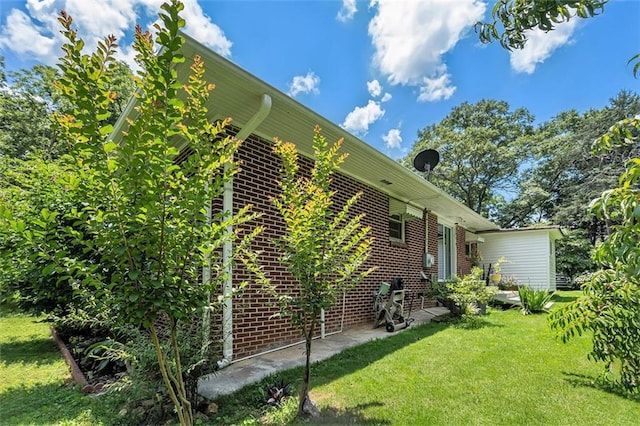 141 Parr Wade Rd SE, Cartersville, GA 30120 - view of property exterior with brick siding, a lawn, and a patio area