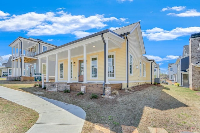 view of home's exterior with a porch and cooling unit