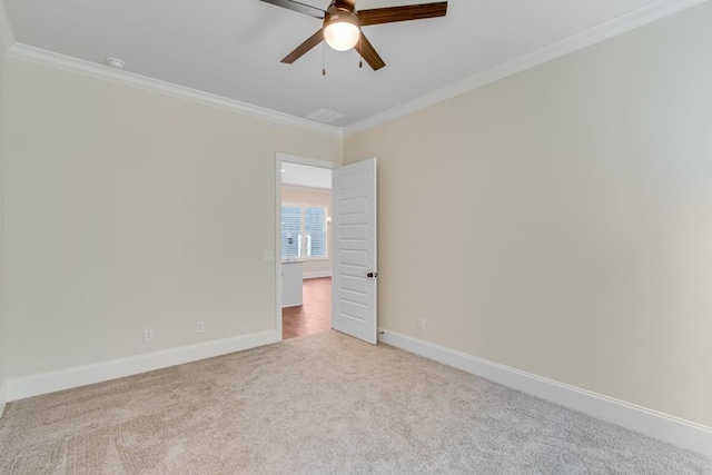 carpeted empty room with ceiling fan and crown molding