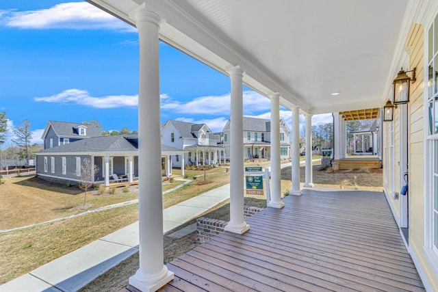 deck with a lawn and covered porch