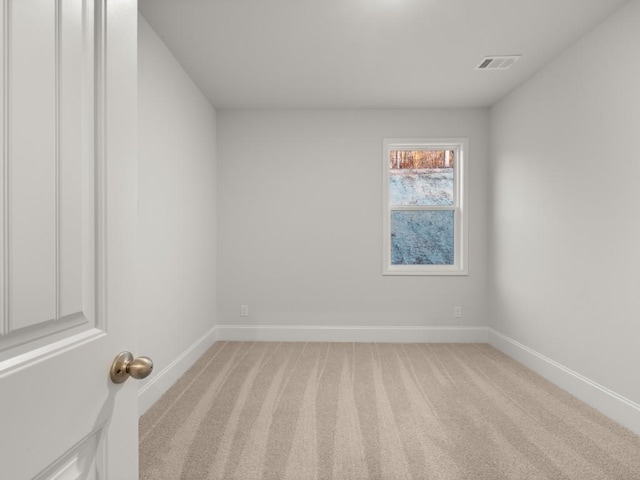 empty room featuring light carpet