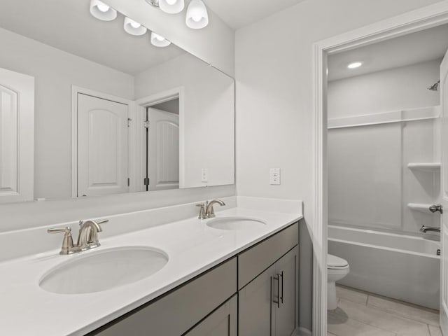 full bathroom with toilet, vanity, and  shower combination