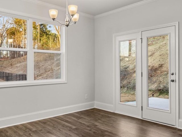 doorway to outside with crown molding, dark hardwood / wood-style flooring, and an inviting chandelier