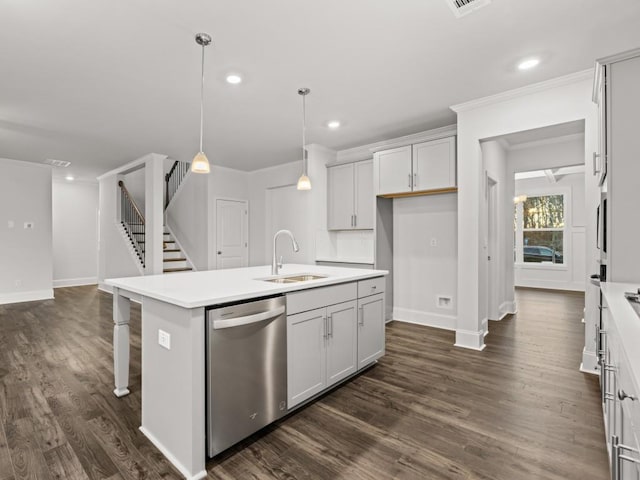 kitchen featuring a center island with sink, decorative light fixtures, dark wood-type flooring, dishwasher, and sink