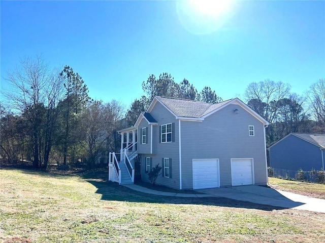 view of side of home with a garage and a lawn