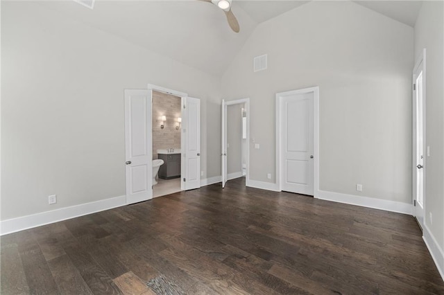 unfurnished bedroom featuring visible vents, high vaulted ceiling, dark wood finished floors, connected bathroom, and baseboards