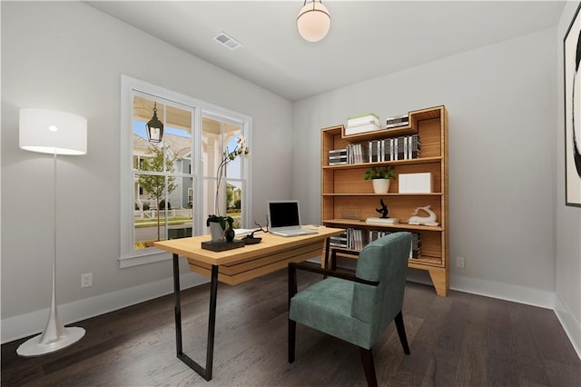 office space with visible vents, dark wood-type flooring, and baseboards