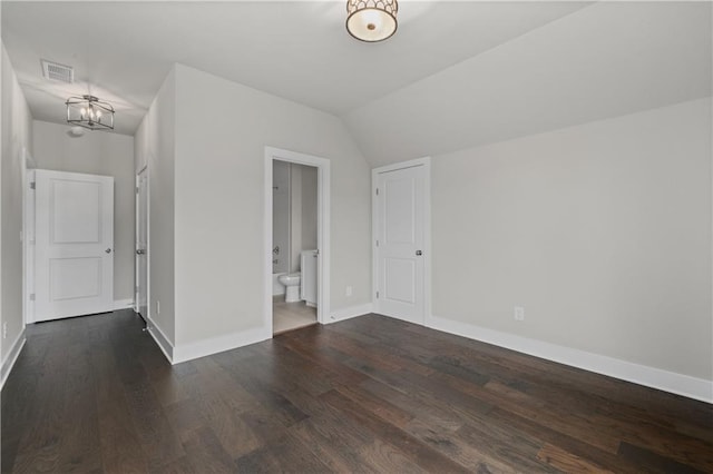 unfurnished room with wood finished floors, visible vents, baseboards, an inviting chandelier, and lofted ceiling