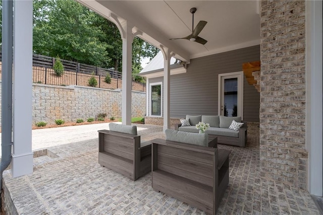 view of patio with outdoor lounge area, a ceiling fan, and fence