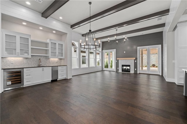 interior space featuring tasteful backsplash, wine cooler, dark wood finished floors, white cabinetry, and open shelves