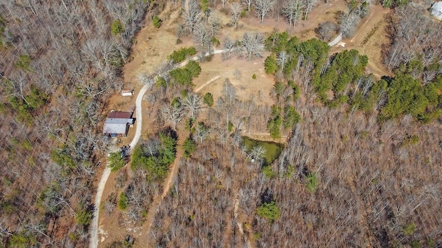 bird's eye view with a wooded view