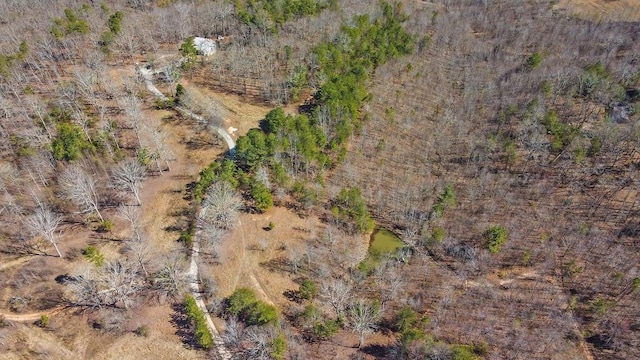 drone / aerial view featuring a forest view