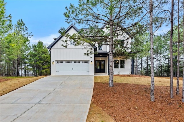 modern inspired farmhouse featuring board and batten siding, concrete driveway, and a garage