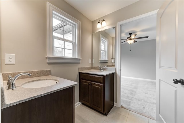 bathroom with tile patterned flooring, ceiling fan, and double sink vanity