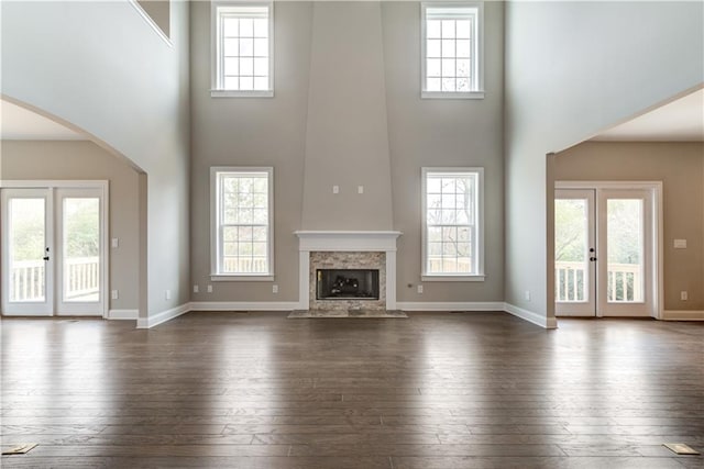 unfurnished living room featuring hardwood / wood-style flooring, a fireplace, and plenty of natural light