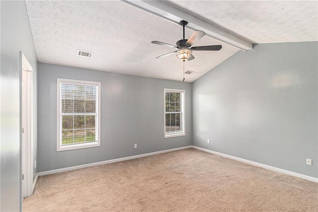 empty room with light colored carpet, visible vents, a textured ceiling, and baseboards