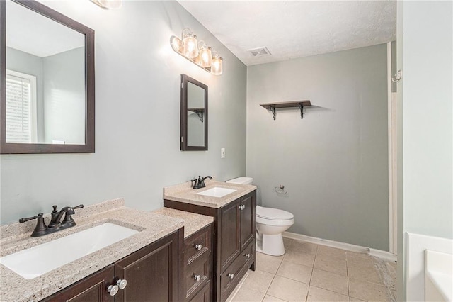 bathroom with toilet, tile patterned floors, a sink, and visible vents