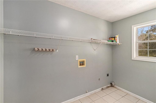 laundry room with baseboards, washer hookup, laundry area, gas dryer hookup, and hookup for an electric dryer
