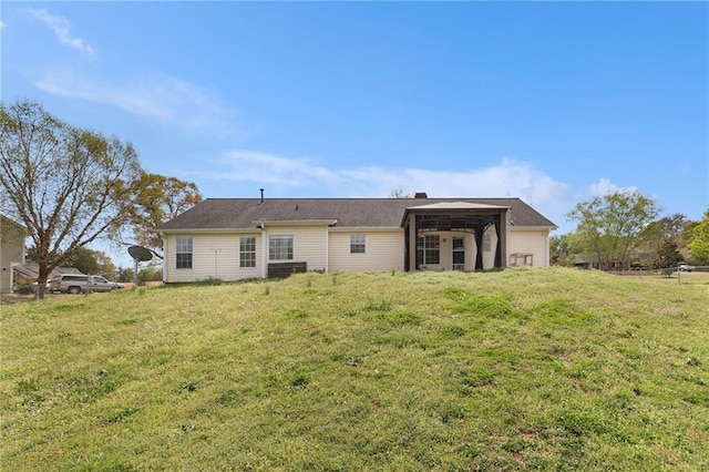 rear view of house with a lawn