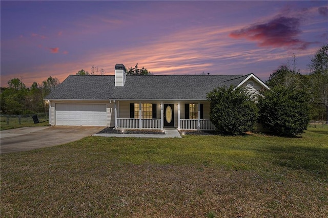 ranch-style home featuring concrete driveway, roof with shingles, an attached garage, a porch, and a lawn