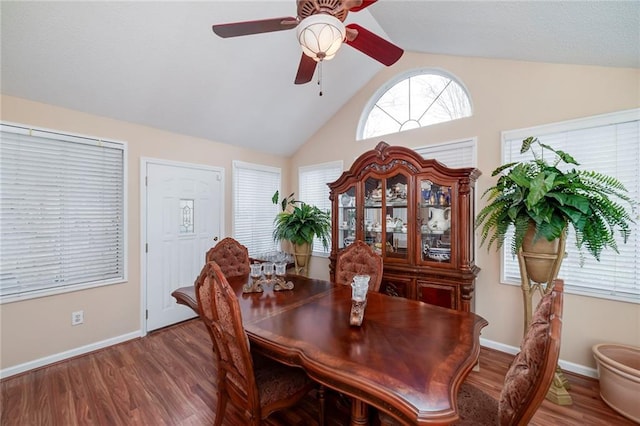 dining space with vaulted ceiling, ceiling fan, and hardwood / wood-style floors