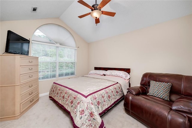 carpeted bedroom featuring multiple windows, vaulted ceiling, and ceiling fan