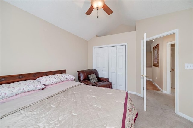 carpeted bedroom featuring ceiling fan, vaulted ceiling, and a closet