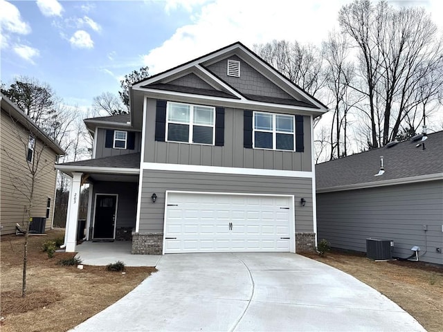 craftsman-style home featuring board and batten siding, concrete driveway, central AC unit, and a garage