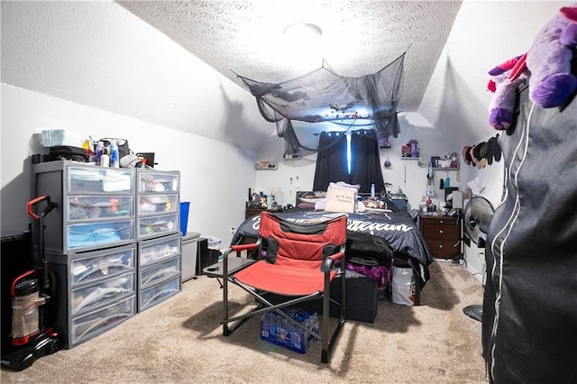 carpeted bedroom with vaulted ceiling and a textured ceiling