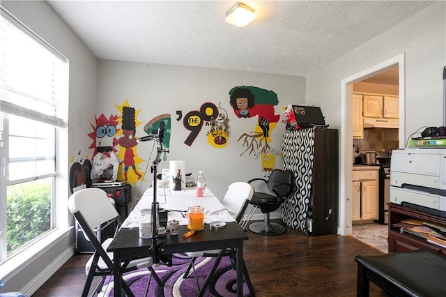 dining space with dark wood-style flooring and a textured ceiling