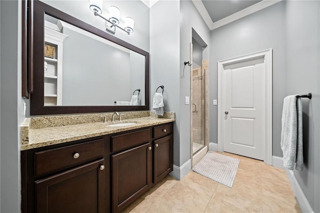 bathroom with vanity, tile patterned floors, crown molding, and a shower with shower door