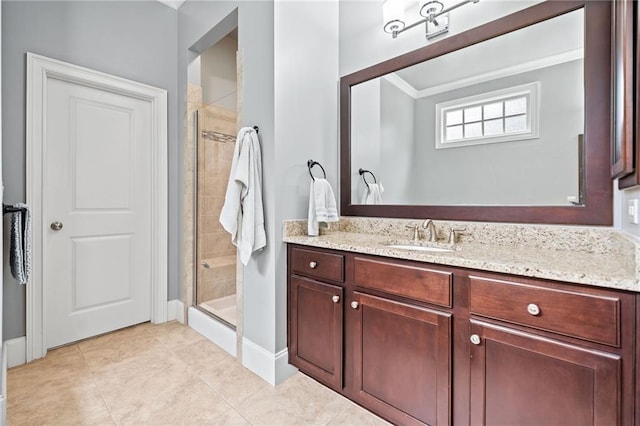 bathroom with tile patterned floors, ornamental molding, a shower with shower door, and vanity