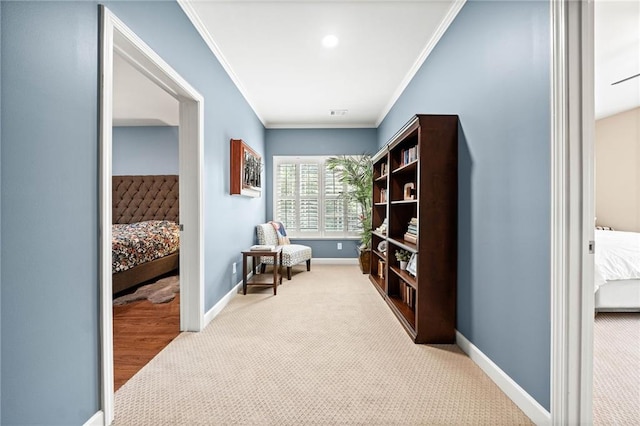 living area featuring crown molding and light colored carpet