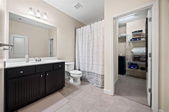 bathroom featuring vanity, tile patterned floors, and toilet