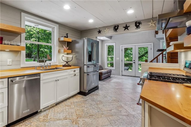 2121 Jep Wheeler Rd, Woodstock, GA 30188 - kitchen with appliances with stainless steel finishes, wooden counters, open shelves, plenty of natural light, and recessed lighting