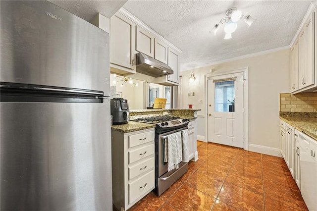 kitchen featuring under cabinet range hood, decorative backsplash, stainless steel appliances, and light stone counters