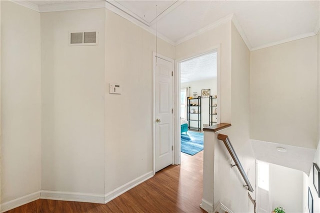 corridor featuring visible vents, an upstairs landing, attic access, and wood finished floors