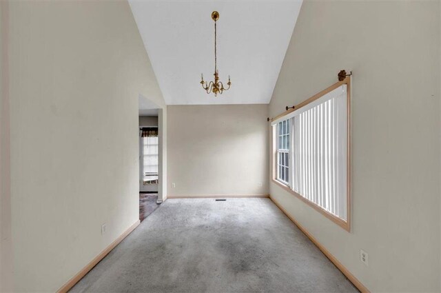 1735 Silver Way, Lithia Springs, GA 30122 - carpeted empty room featuring a chandelier and vaulted ceiling