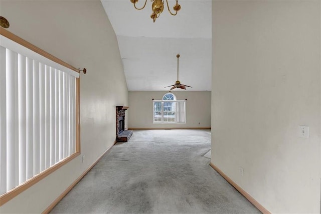 1735 Silver Way, Lithia Springs, GA 30122 - unfurnished living room featuring carpet floors, high vaulted ceiling, a chandelier, a fireplace, and a ceiling fan