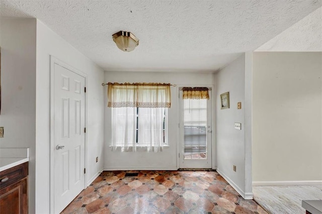 1735 Silver Way, Lithia Springs, GA 30122 - unfurnished dining area featuring baseboards and a textured ceiling