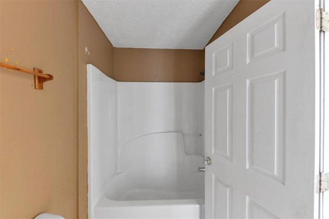 1735 Silver Way, Lithia Springs, GA 30122 - bathroom with a textured ceiling and shower / bath combination