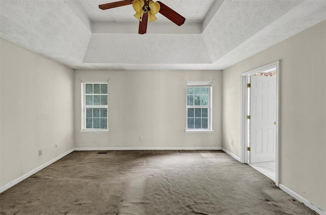 1735 Silver Way, Lithia Springs, GA 30122 - carpeted empty room with a tray ceiling, ceiling fan, and a textured ceiling