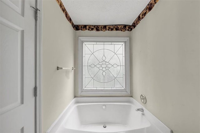 1735 Silver Way, Lithia Springs, GA 30122 - bathroom with a garden tub and a textured ceiling